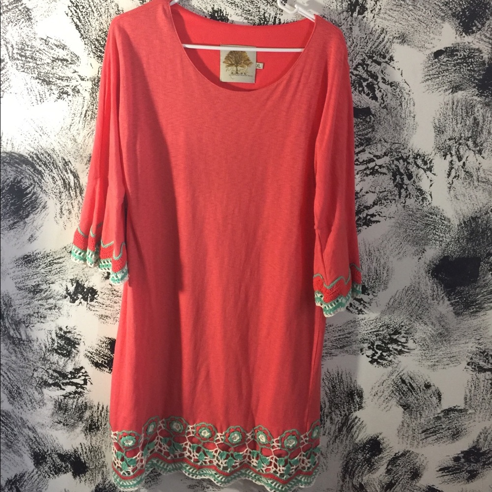 coral dress with embroidery on trim
